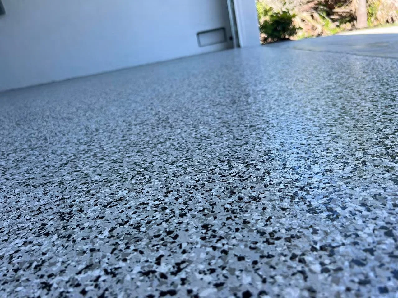 Shiny epoxy garage floor with metallic finish in residential home