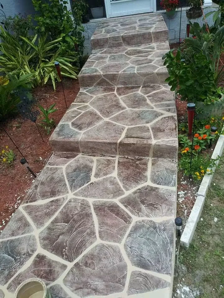 Flagstone-patterned concrete walkway with light grout joints and textured finish