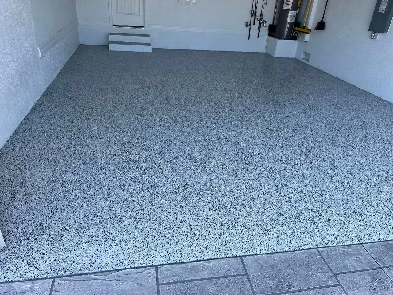 Gray speckled epoxy garage floor with seamless finish and clean edges